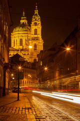 Fototapeta na wymiar Prague street with Saint Nicolas church