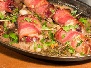 bacon wrapped chicken livers in a pan