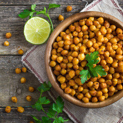 Roasted  spicy chickpeas on rustic background