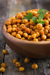 Roasted  spicy chickpeas on rustic background
