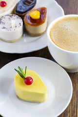 Fototapeta premium delicious mini cakes and a cup of coffee