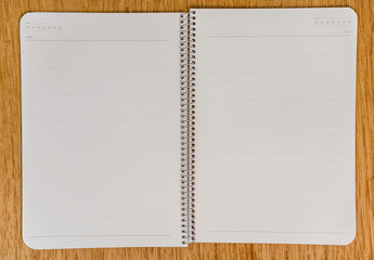 Notebook paper with on wooden background