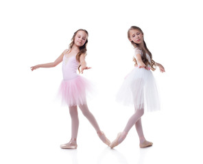 Naklejka premium Cute sisters-ballerinas isolated on white backdrop