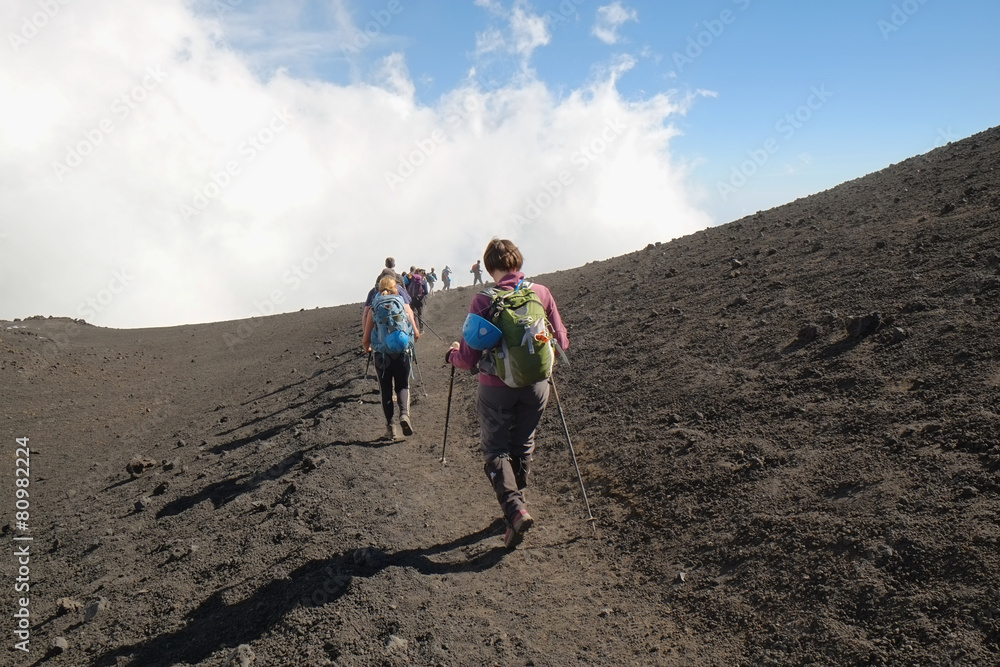 Wall mural hikers going down the summit etna crater, sicily