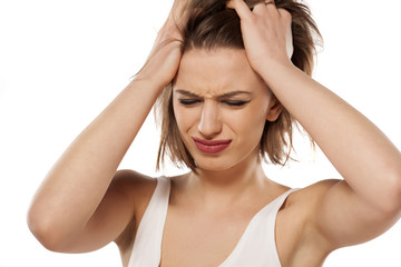 Fototapeta premium beautiful young woman has a bad headache