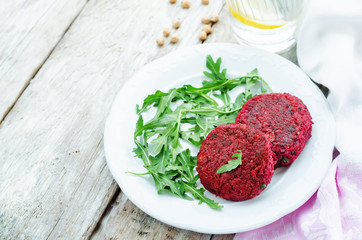 chickpeas, quinoa and beet burgers with arugula