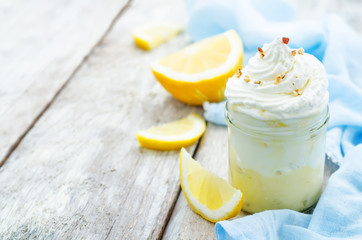 layered dessert with lemon cream, ice cream and whipped cream