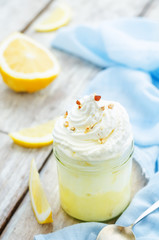 layered dessert with lemon cream, ice cream and whipped cream