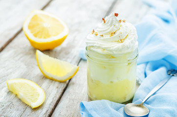 layered dessert with lemon cream, ice cream and whipped cream