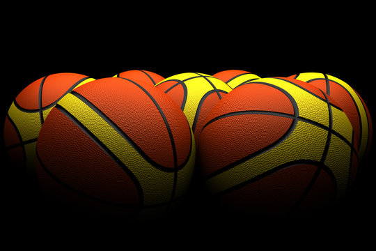 group basketballs orange and yellow on a black background