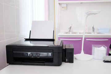 Black printer and paper closeup