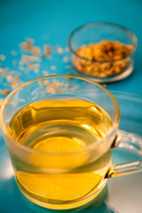 Cup of Herbal Tea on blue Background