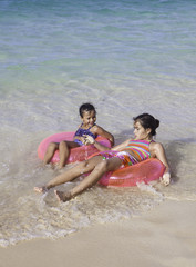 Fototapeta premium sisters with float tubes
