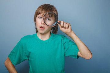 teenager boy brown European appearance in a green shirt looking