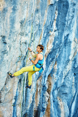 Rock climber climbing up a cliff