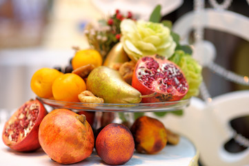 Naklejka na ściany i meble Glass dish with assortment fruits as decoration