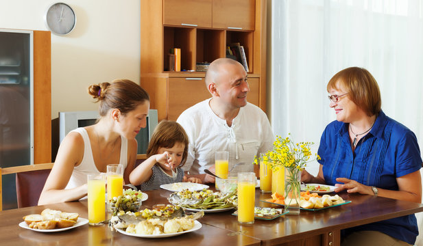  multigeneration family  eating fish with vegetables