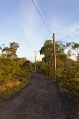 Australian Dirt Road with Electric Poles in Sunset