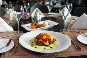 Seafood appetizer and dessert on restaurant table