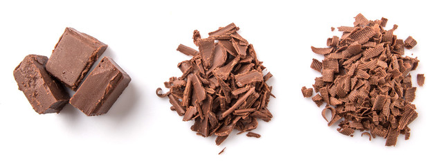 Dark brown chocolate pieces over white background