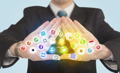 Hands creating a form with mobile app icons