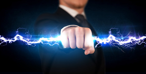 Business man holding electricity light bolt in his hands