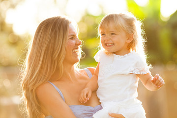 Happy mother and daughter smiling
