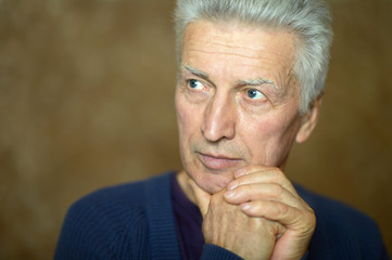 Pensive elderly man at home