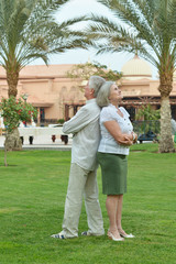 Fototapeta na wymiar Senior couple at tropic hotel garden
