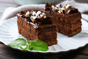 Tasty pieces of chocolate cake with mint