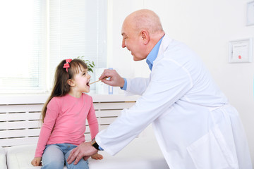 Little girl and old doctor in hospital