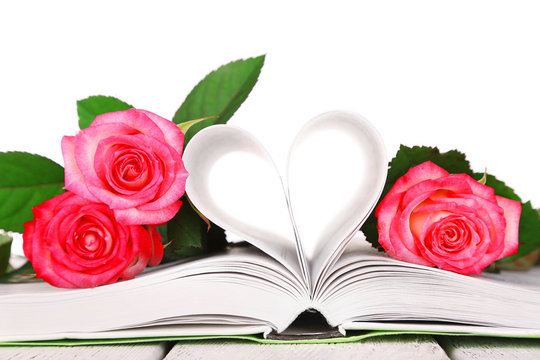 Open book with beautiful roses isolated on white