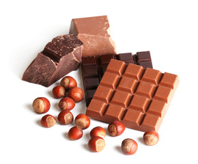 Milk and black chocolate bars with hazelnuts isolated on white