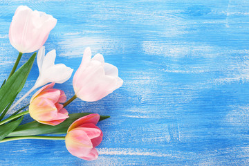 Fototapeta na wymiar Beautiful tulips on color wooden background