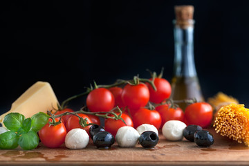 Italian classic ingredients for pasta on black background