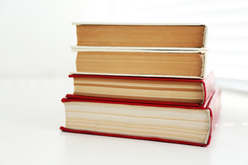 Books on white windowsill, close up