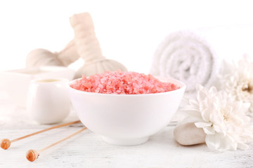 Spa still life with color sea salt on wooden table, closeup