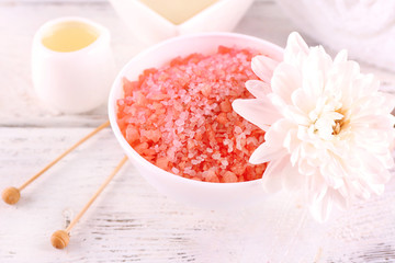 Spa still life with color sea salt on wooden table, closeup