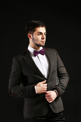 Elegant man in suit on dark background