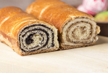 Poppy seed and walnut cakes on wooden background