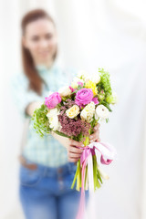 Bunch of random flowers closeup in florist's hands