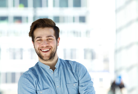 Attractive modern young man with beard smiling
