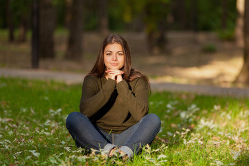 The girl meditates in park