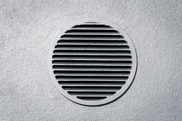 Vent window on gray concrete wall