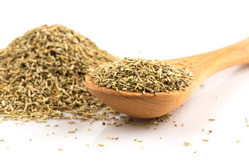 Dried rosemary leaves in wooden spoon
