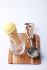 yellow passion fruit ice cream cone with special scoop spoon