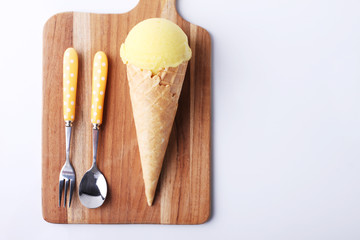 yellow passion fruit ice cream cone with spoon
