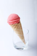red strawberry ice cream cone in a glass