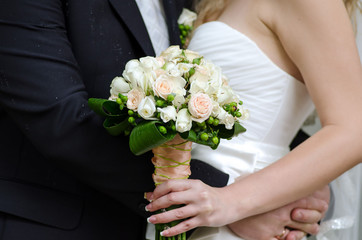 The groom hugging his bride
