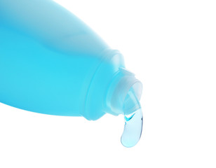 Cosmetic liquid pouring from bottle isolated on white